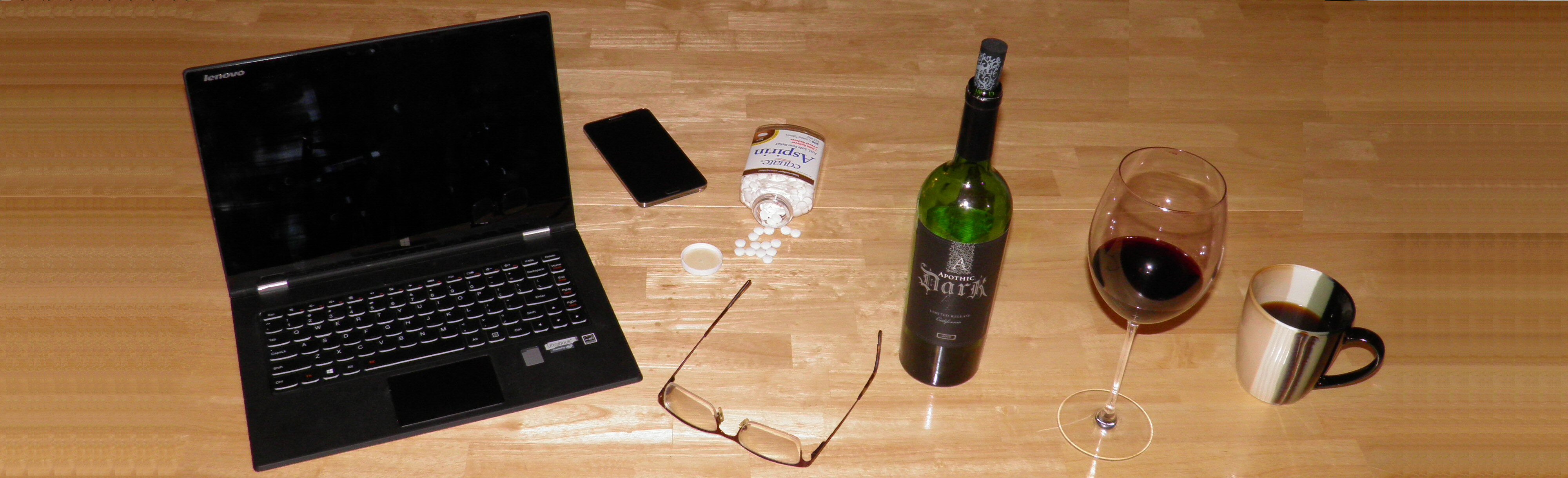 Writer's desk with laptop and wine